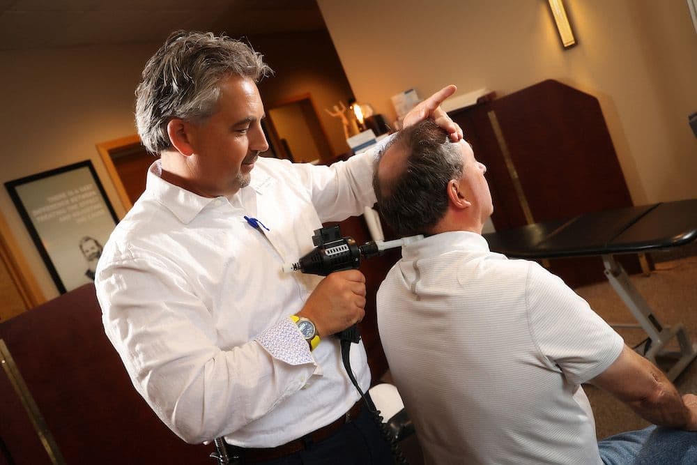 Precise instrument-assisted chiropractic adjustment at CornerStone Chiropractic clinic in Minot, ND